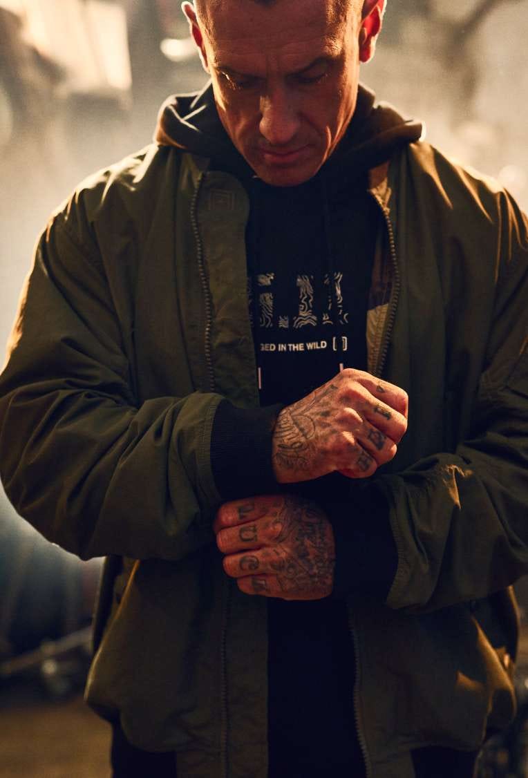 Carey Hart fixes his cuffs