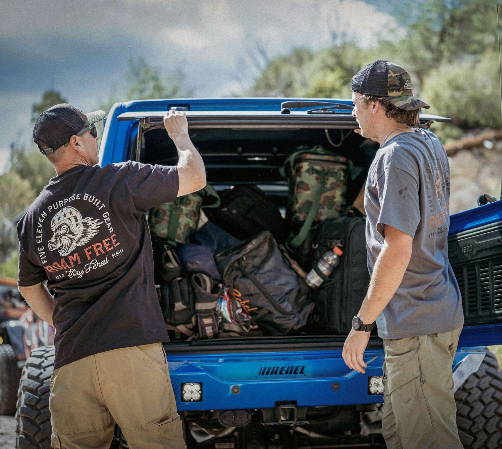 Two men unloading a vehicle