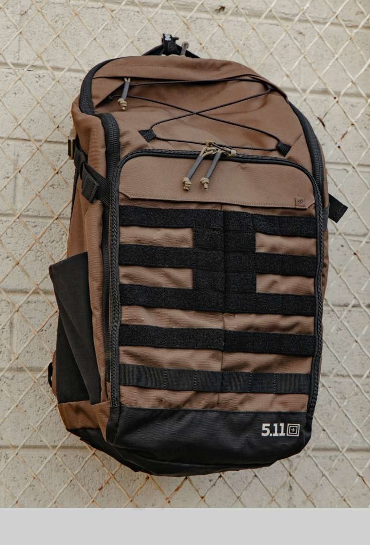 MVR backpack hangs off a chain link fence