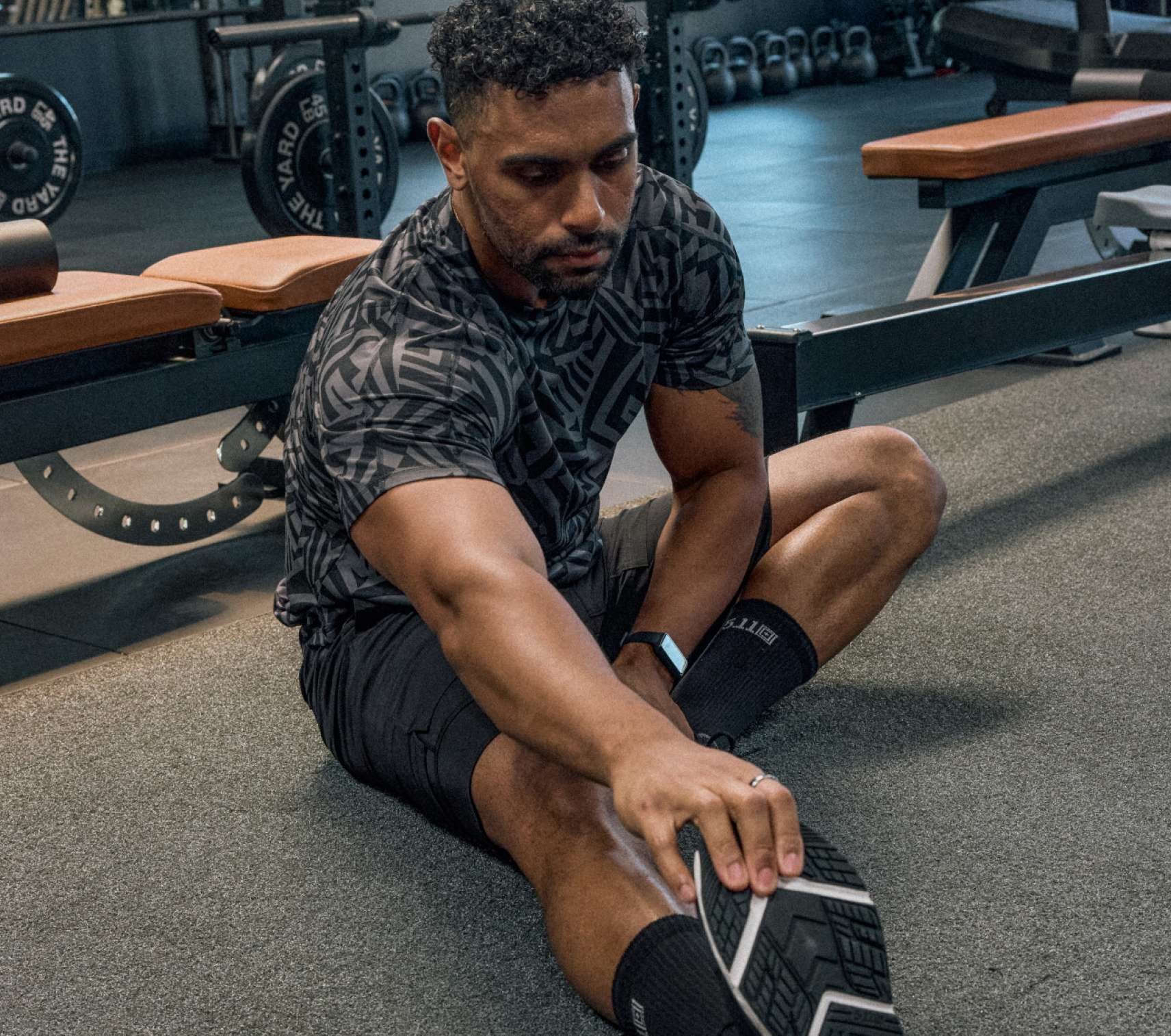 Man stretching on a gym floor