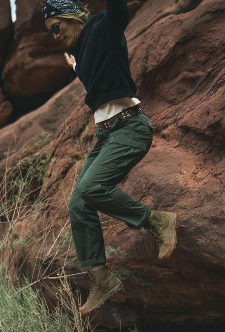 Woman hops down a short rock