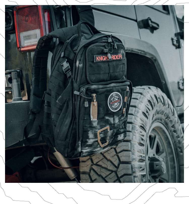 A RUSH® 24 Backpacks hangs off the back of a vehicle