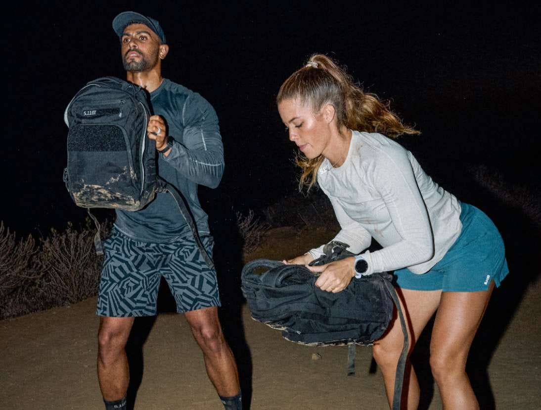 Man and woman use the weighted Ruck Pack to work out