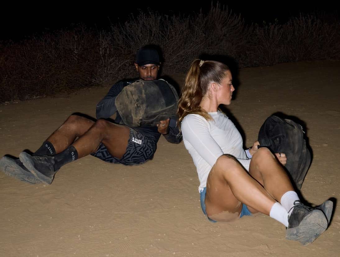 Man and woman use the weighted Ruck Pack to work out