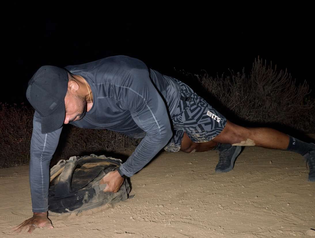Man uses the weighted Ruck Pack to work out