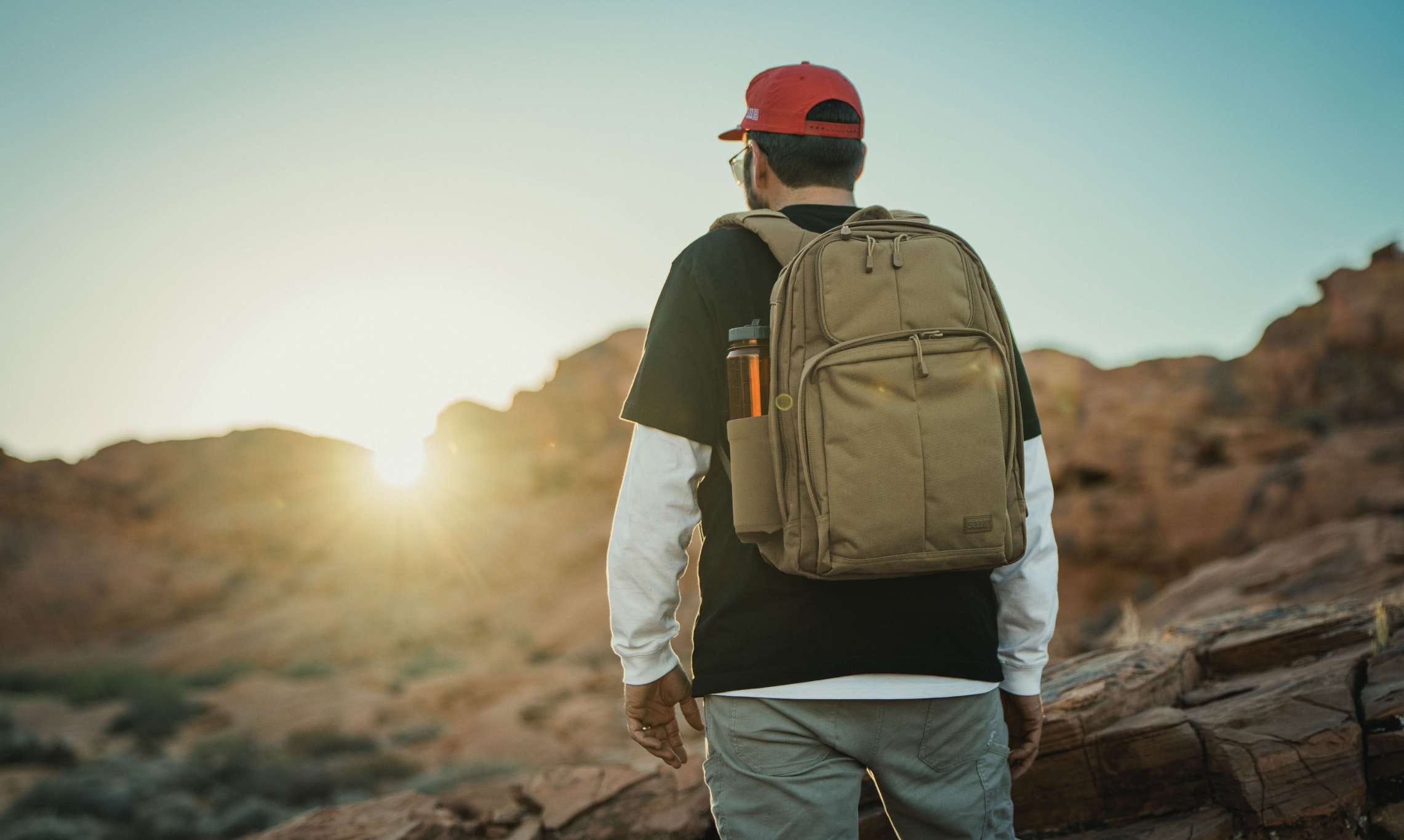 Man wears RUSH Shadow, overlooking a sunset