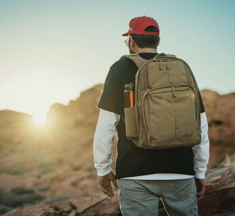 Man wears RUSH Shadow, overlooking a sunset