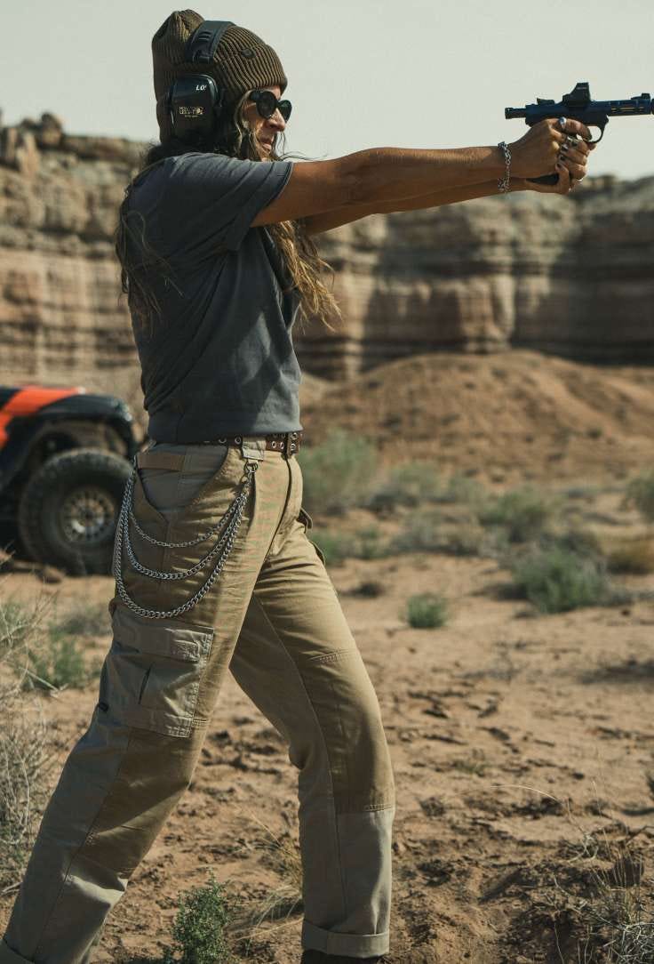 Woman fires a pistol on a shooting range