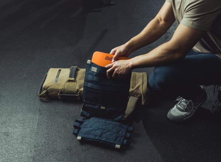 Person loads flex plates into the weight vest