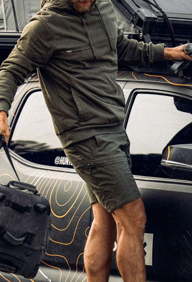 Man wearing shorts walks by a truck