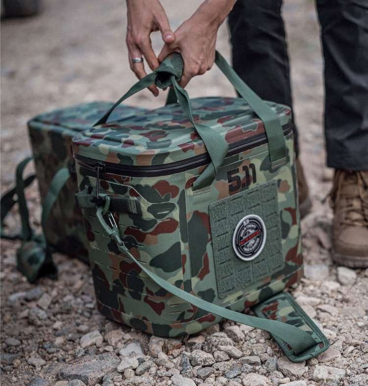 Camo cooler on the ground being picked up