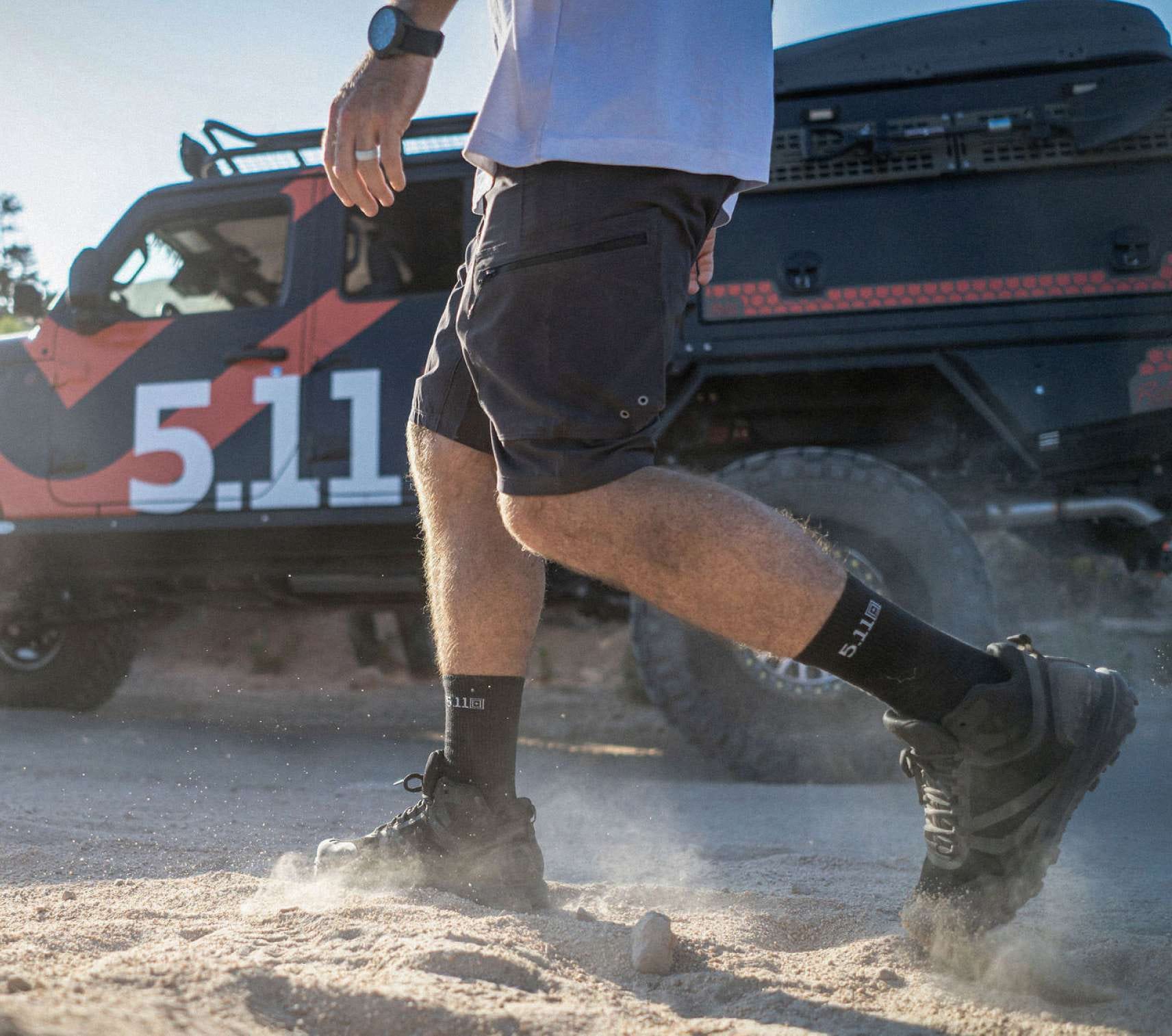 Man wearing black shorts walking in dirt