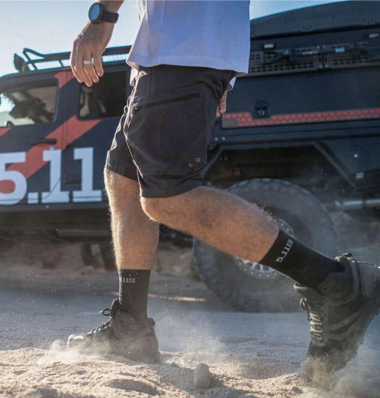 Man wearing black shorts walking in dirt
