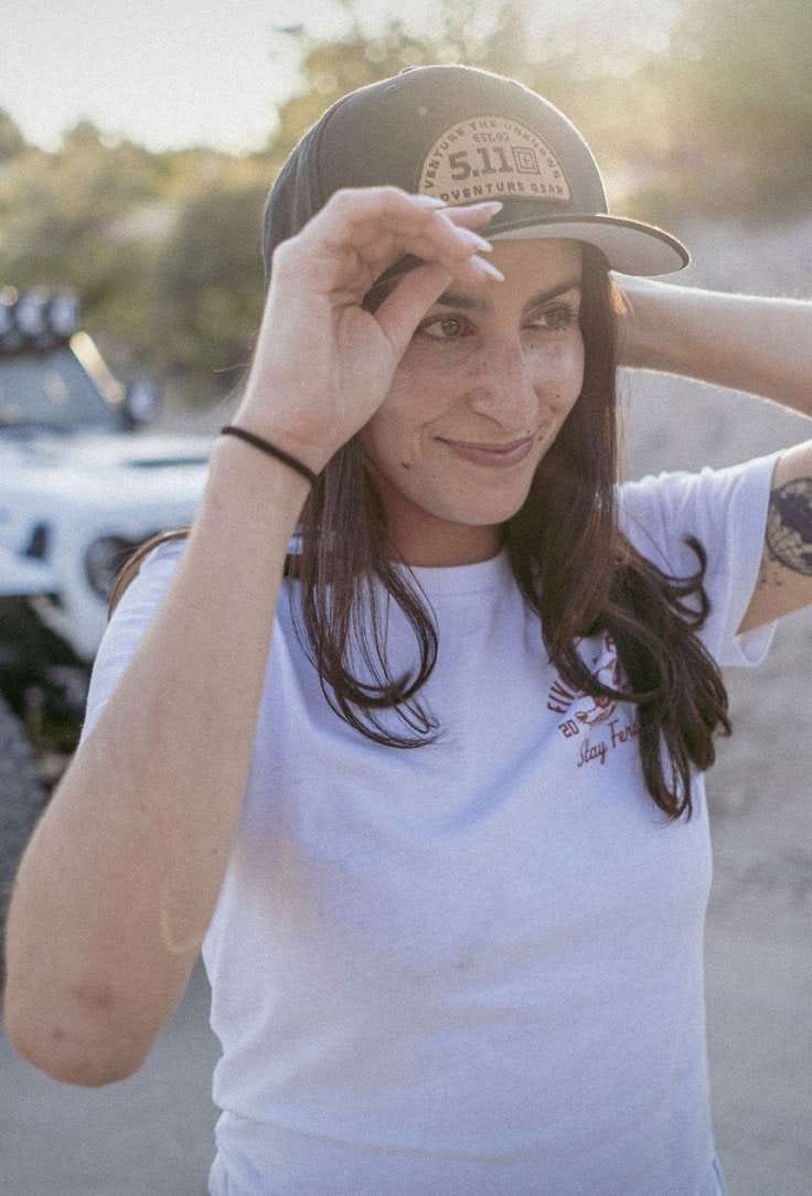 Woman wearing white tshirt and black hat
