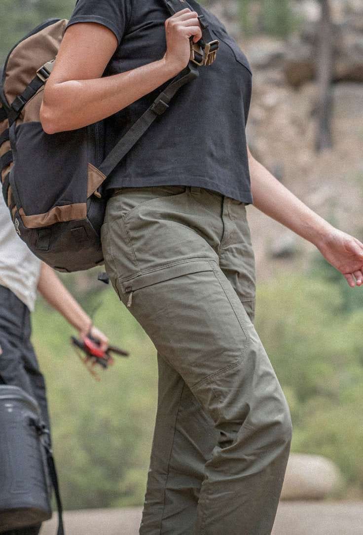 Woman wearing green pants walking