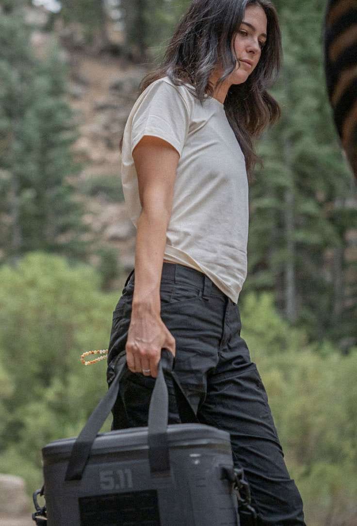 Woman walking with a cooler in hand