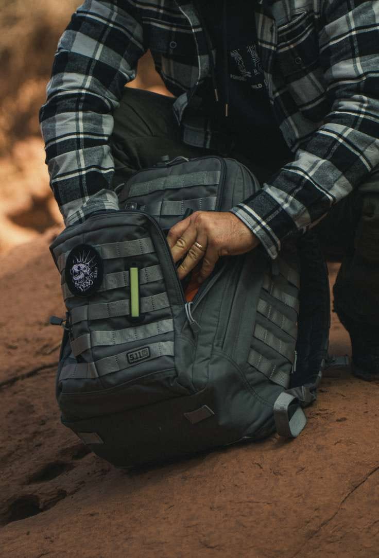 Man looking through backpack