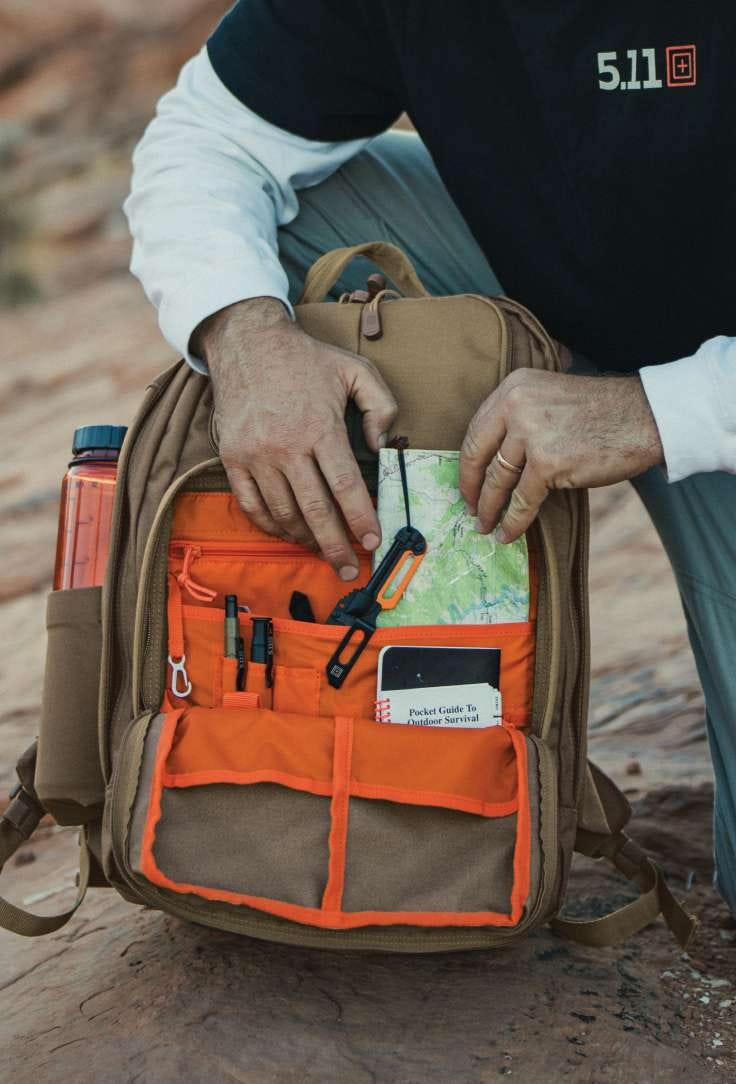 Man looking through backpack