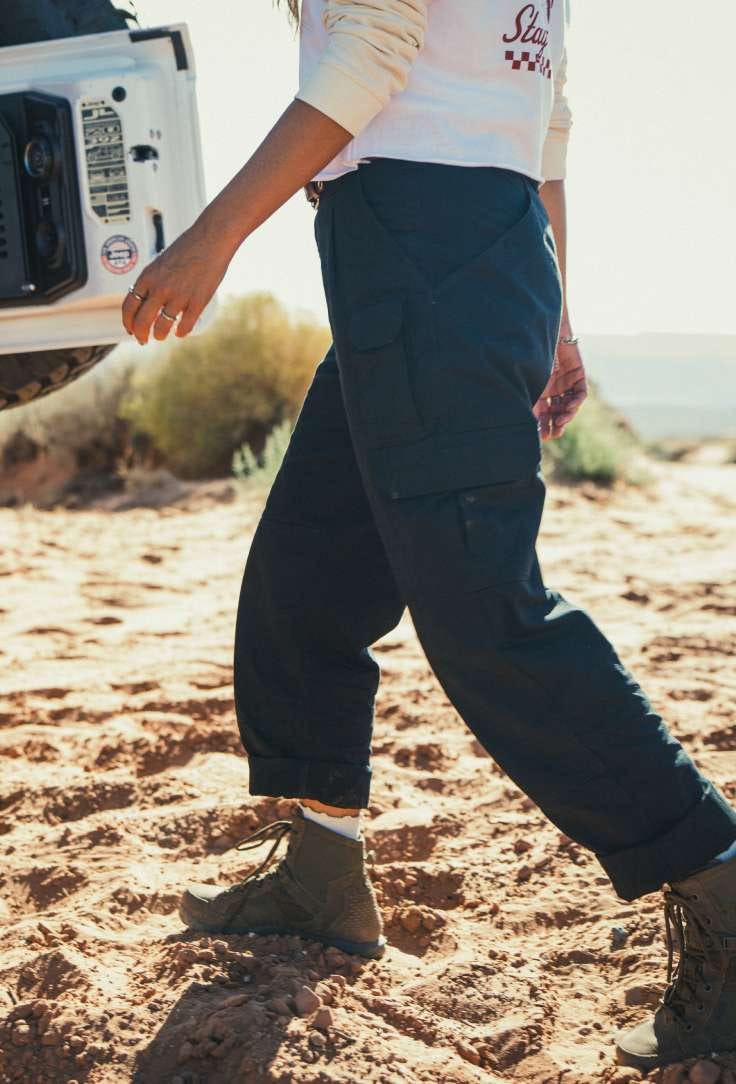 Woman wearing black pants walking