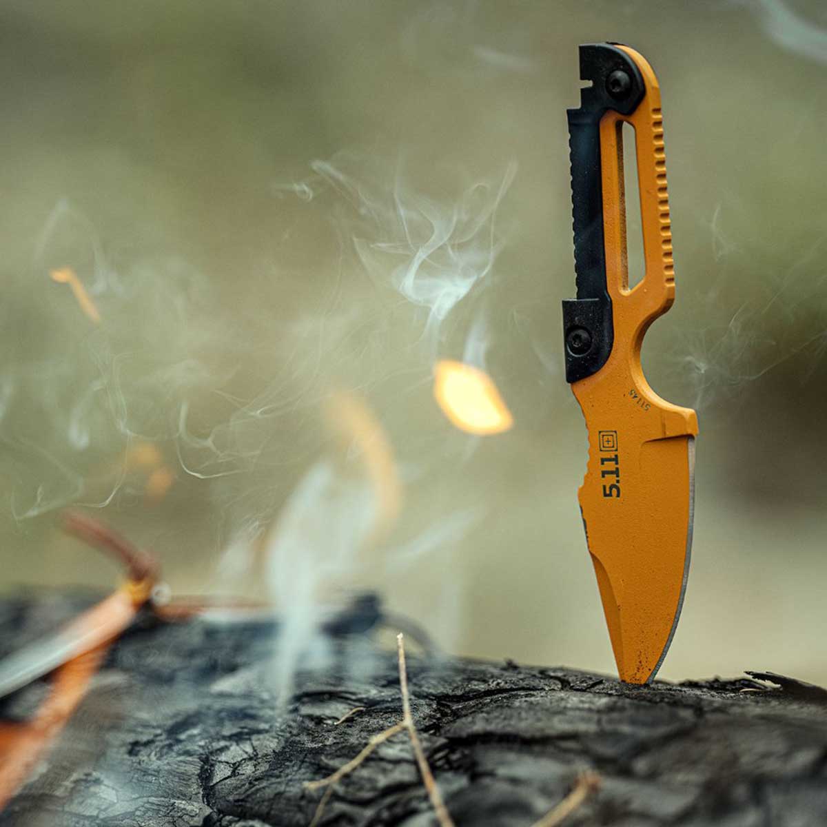 Knife on a burning log.