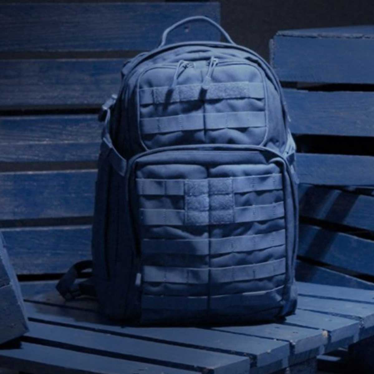 Blu Rush backpack standing on a blue wooden surface.