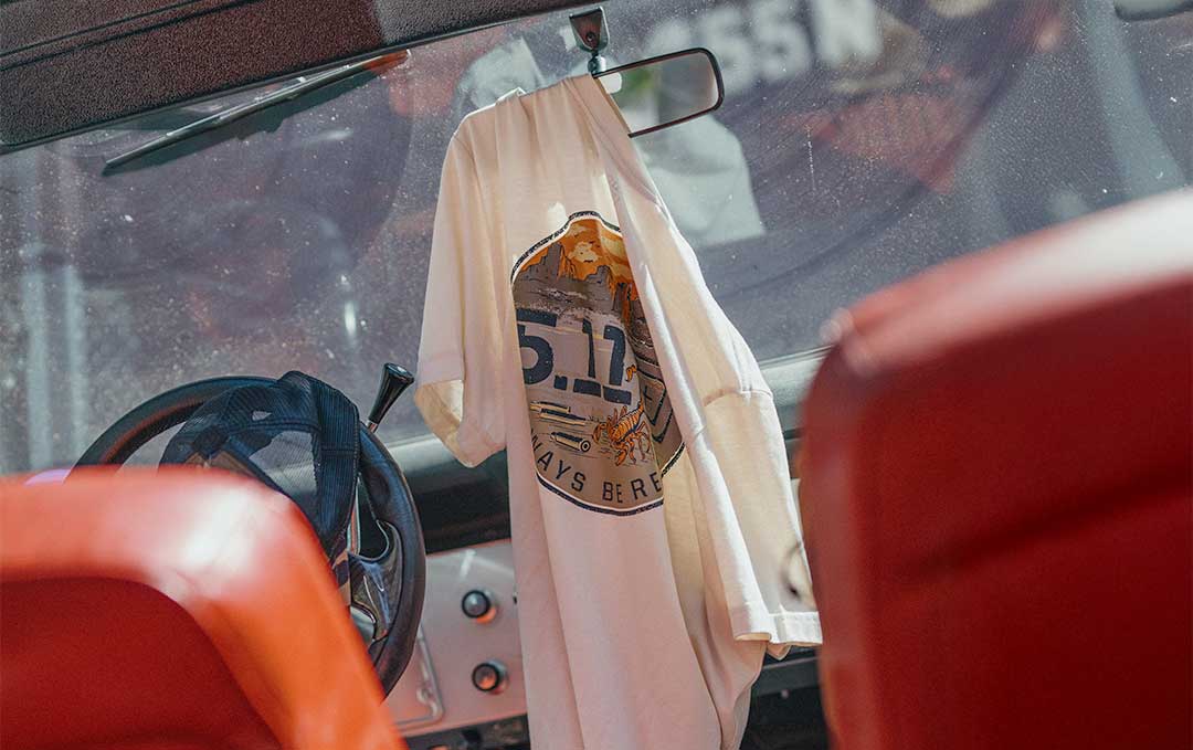 A 5.11 graphic T-shirt hanging inside a vehicle, ready for everyday wear and use.