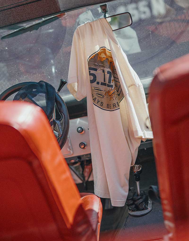 A 5.11 graphic T-shirt hanging inside a vehicle, ready for everyday wear and use.