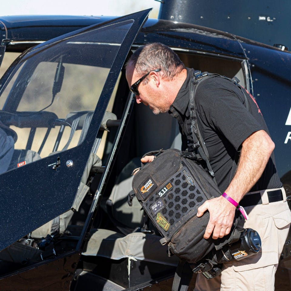 Andrew Eaton loading his AMP10 Go-Bag in the chopper AMP10 Tactical Go-Bag